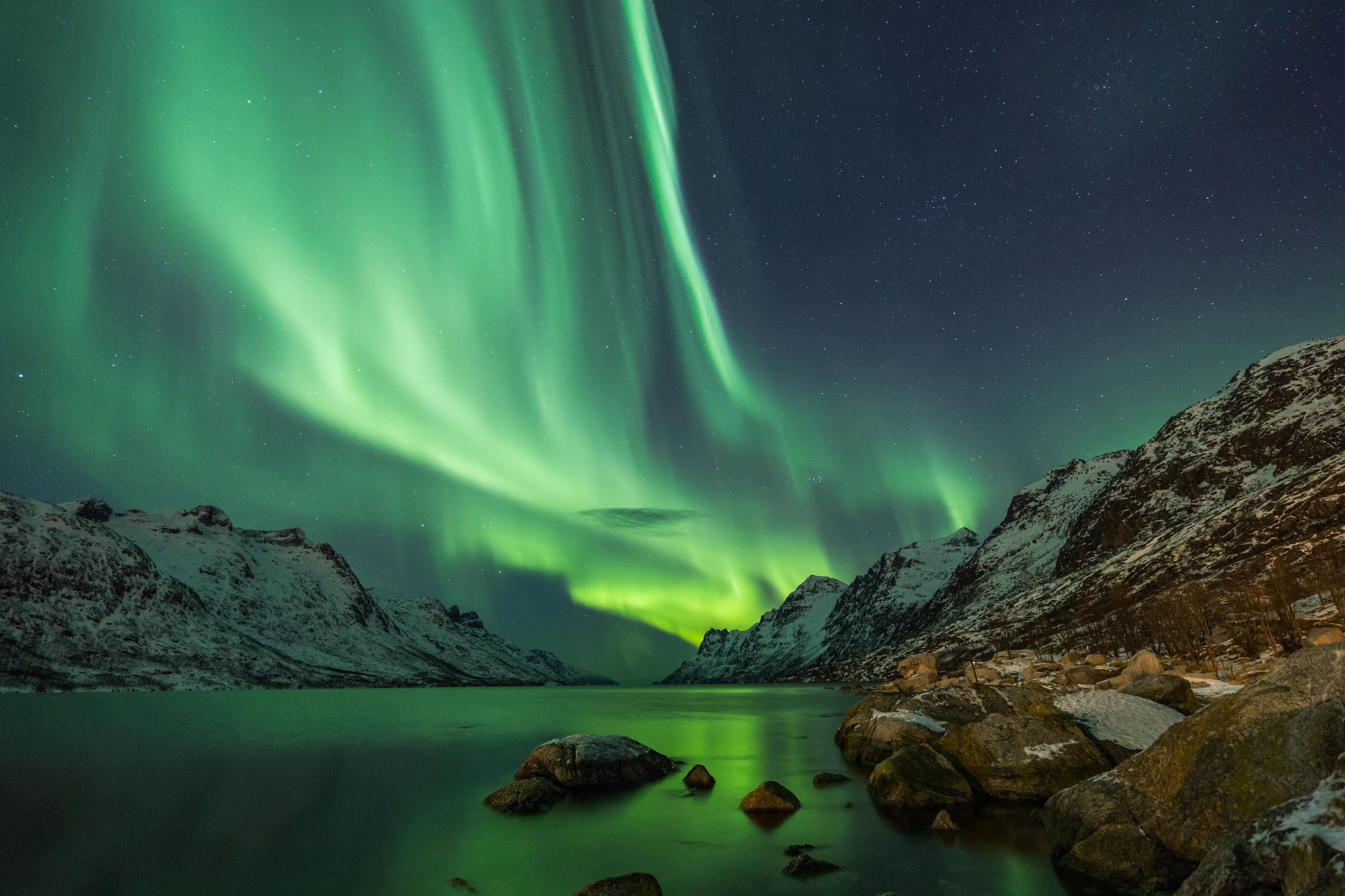 Northern lights over a mountain lake